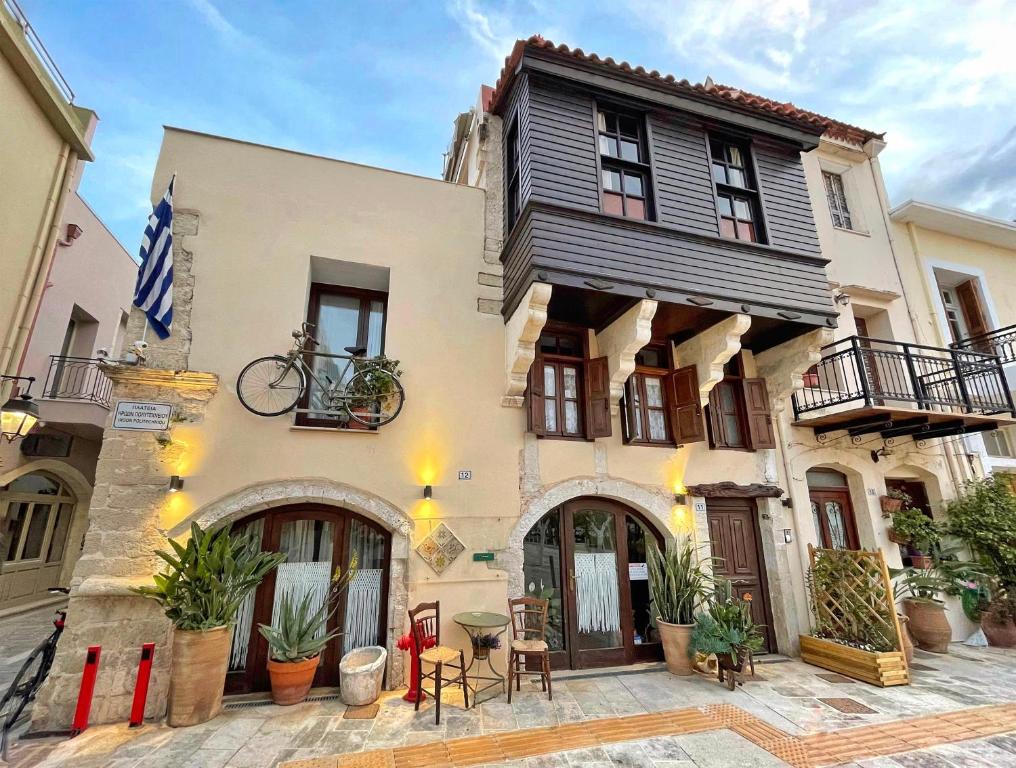 a house with a bicycle on the front of it at Four Seasons of Bliss at Sohora Hotel in Rethymno