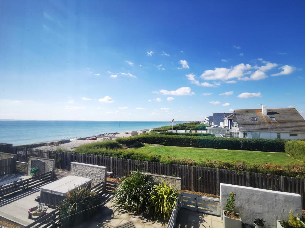 a view of the beach from the balcony of a house at Sea View 3 bedroom seaside property in Chichester