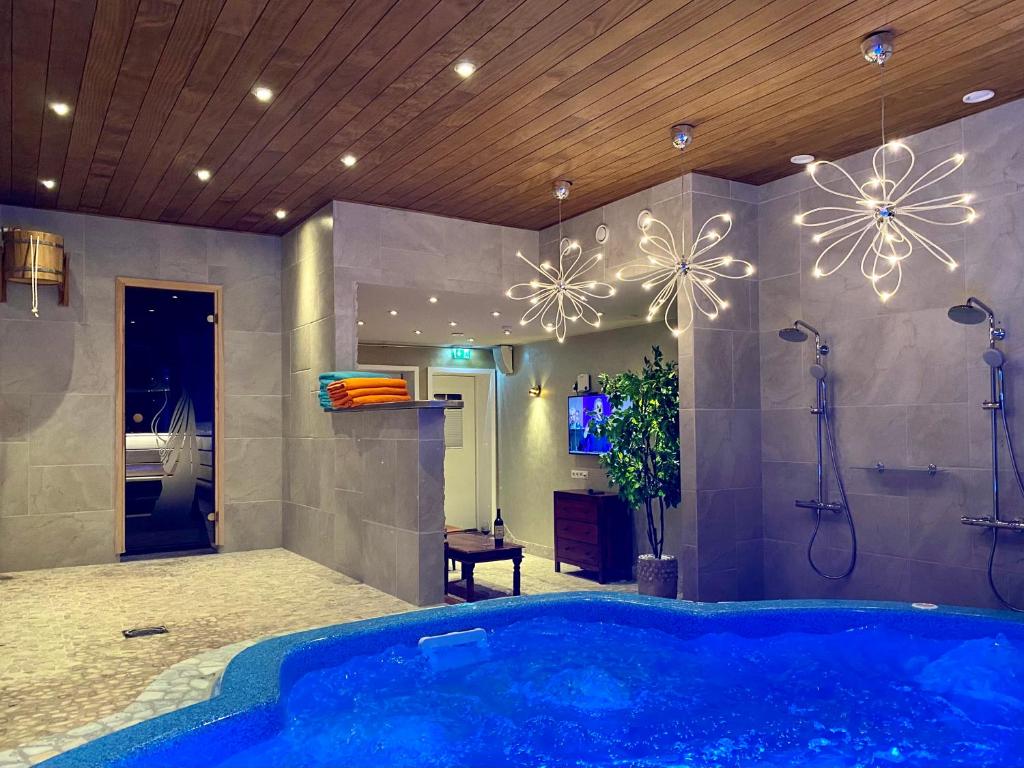 a bathroom with a large blue tub in a room at Kärde Puhkemaja in Kärde