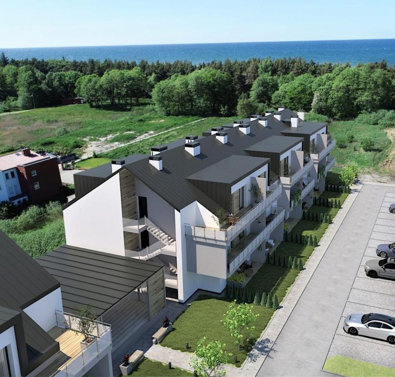 an aerial view of a house with a parking lot at Apartament Coral in Grzybowo