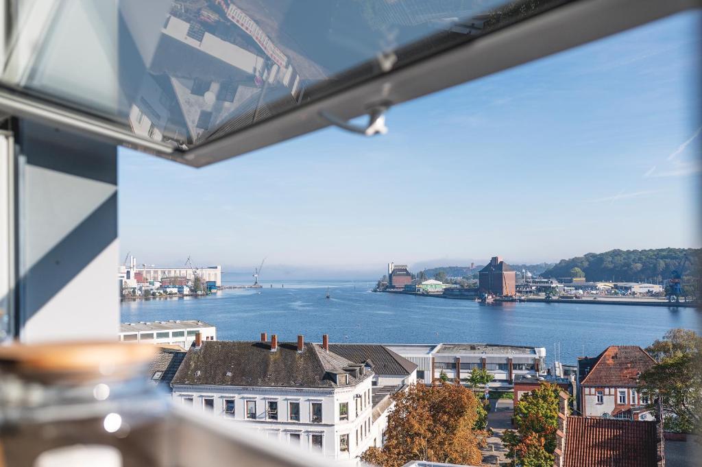 a view of a river from a window at FEWO Fördeblick in Flensburg