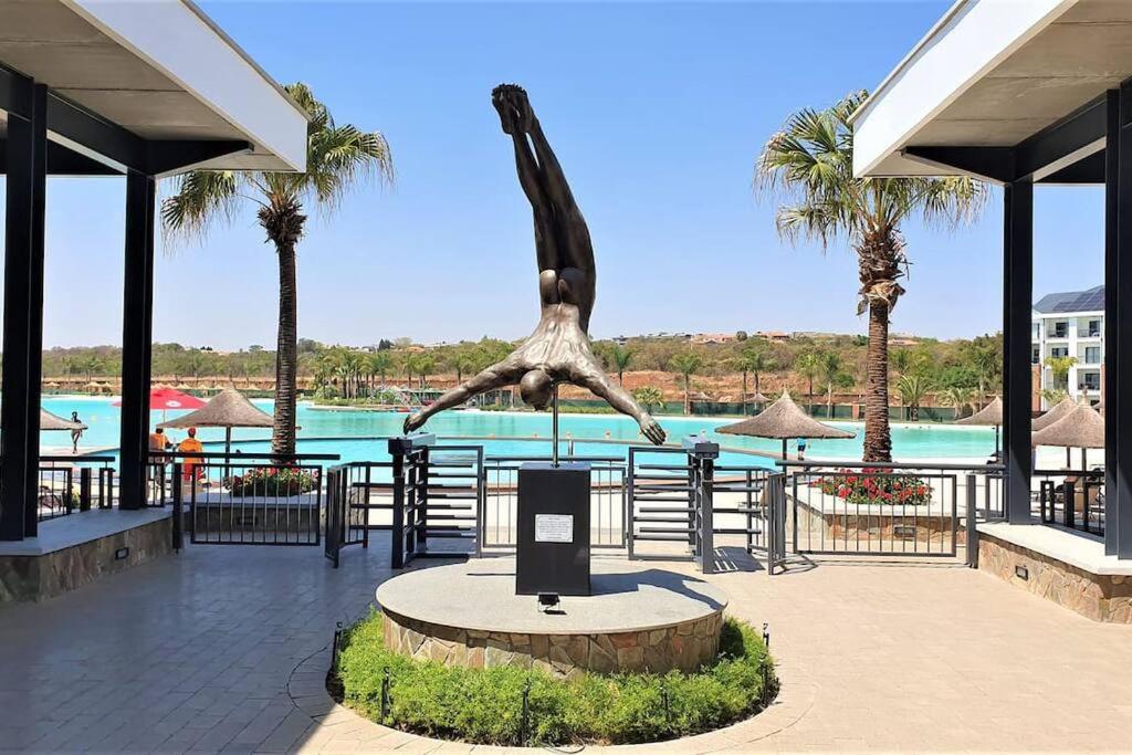 a statue of a giraffe in front of a pool at Crystal lagoon View 3Bed Apartment in Pretoria