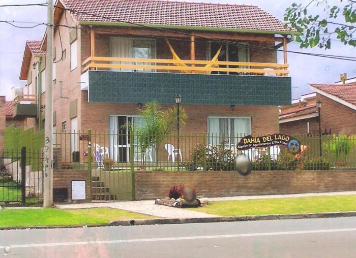 a person laying on the sidewalk in front of a house at BAHIA DEL LAGO in Villa Carlos Paz
