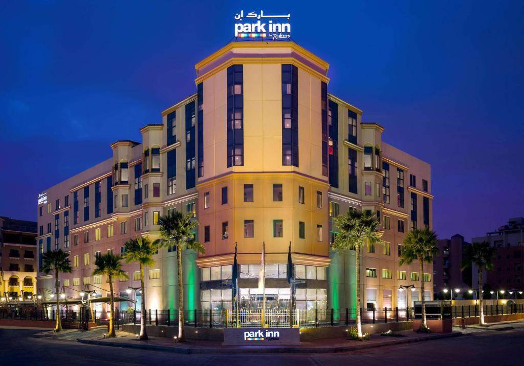 a large building with a sign on top of it at Park Inn by Radisson Al Khobar in Al Khobar