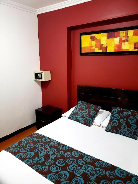 Postel nebo postele na pokoji v ubytování Hotel Fidenzi Bogotá