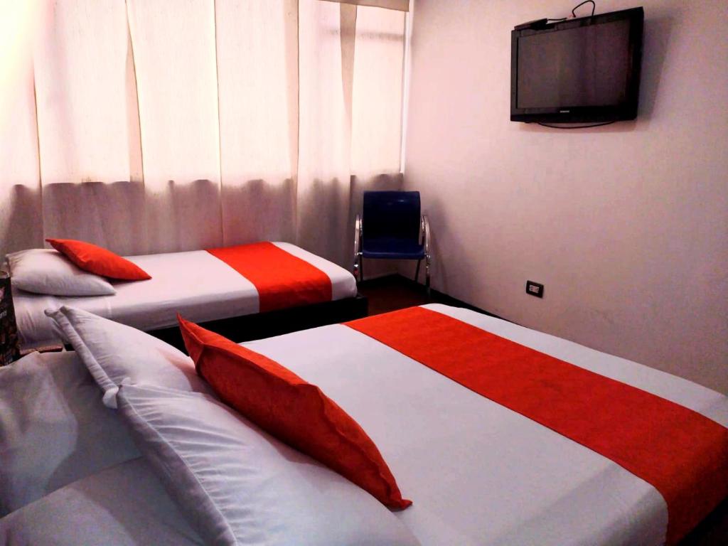 Postel nebo postele na pokoji v ubytování Hotel Fidenzi Bogotá