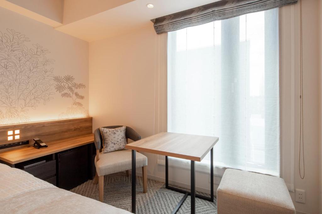 Postel nebo postele na pokoji v ubytování Tokyu Stay Shinjuku Eastside