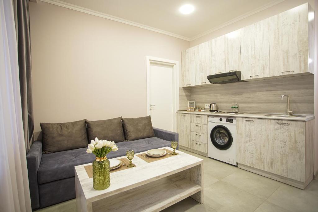 a living room with a couch and a table at Koghbatsi Aparthotel in Yerevan