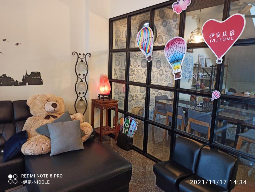 a teddy bear sitting on a couch in a room at 伊家民宿Yi home 志航路一段398號 in Taitung City