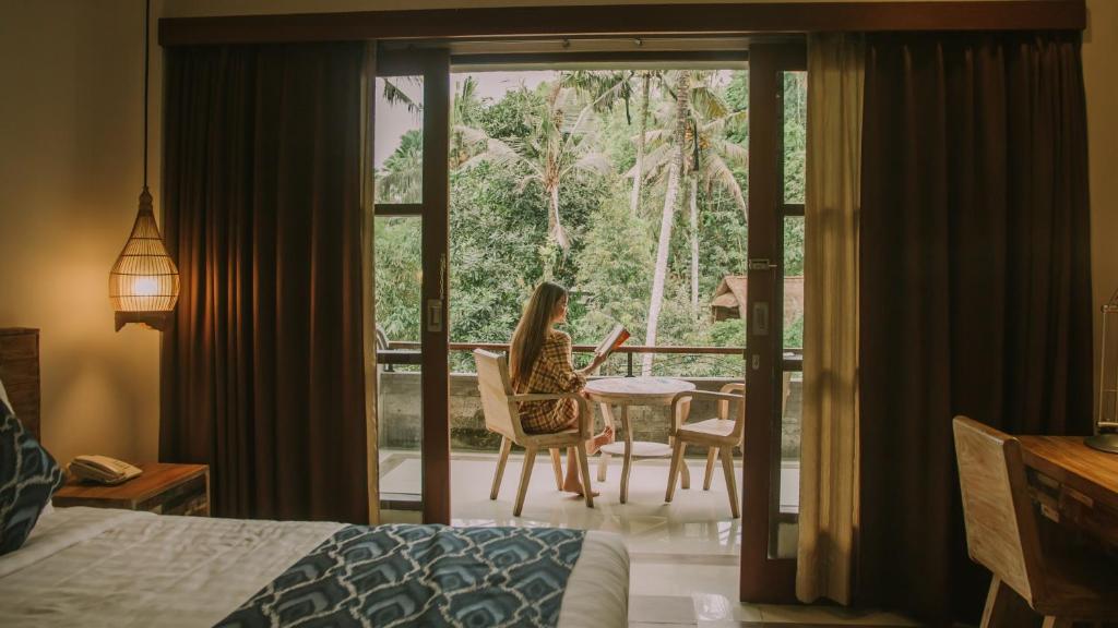 Postel nebo postele na pokoji v ubytování The Artini Dijiwa Ubud