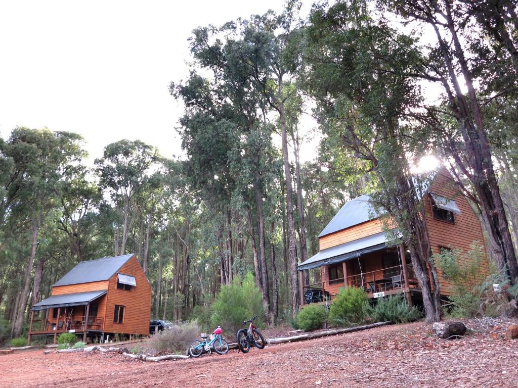 two people on bikes parked in front of a house at Noble River Estate in Dwellingup