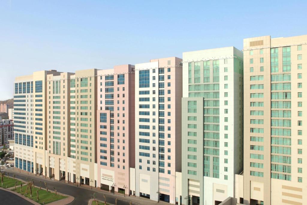 a large white building with many windows at Le Meridien Towers Makkah in Makkah