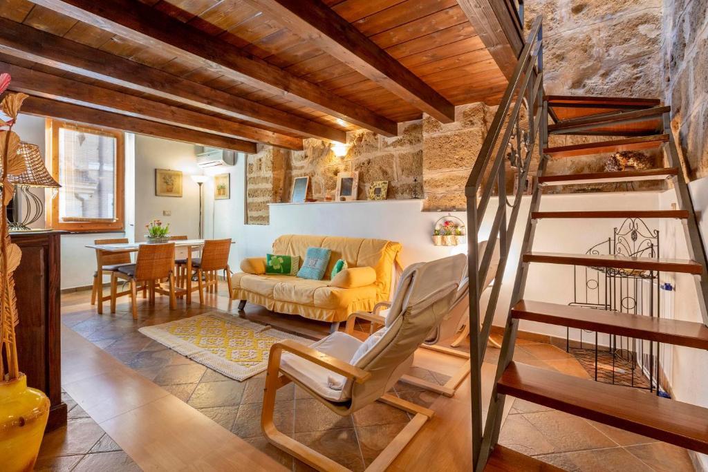 uma sala de estar com uma escada e um sofá em Emerald Top in Old Town by sea em Alghero