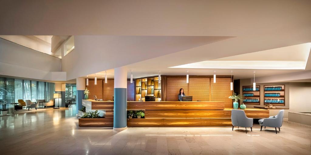 a large lobby with a table and chairs at Aminess Vival Maestral Hotel in Novigrad Istria