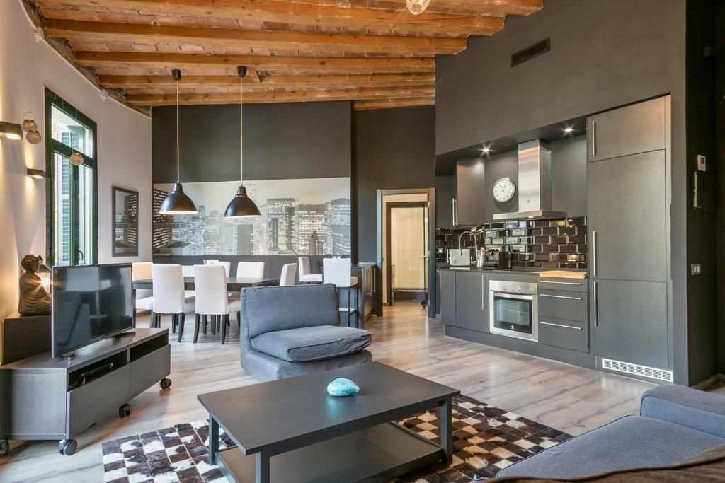 a living room with a kitchen and a dining room at Midtown Luxury Apartments by Sweet Inn in Barcelona