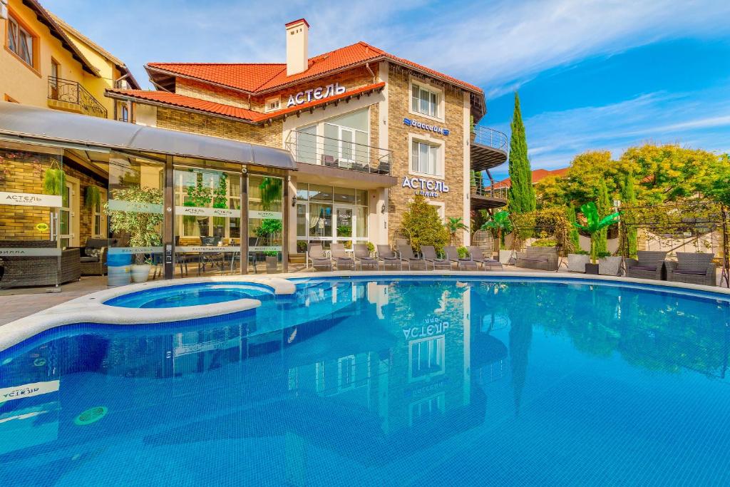 a large swimming pool in front of a building at Отель Астель Вилла in Gelendzhik