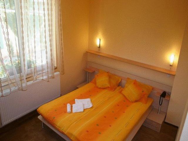 a bedroom with a bed with two towels on it at Suri Guesthouse in Braşov