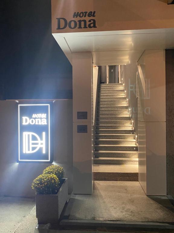 a sign for a hotel in a building with stairs at Dona, Altina in Belgrade