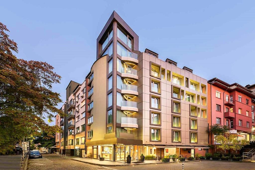 a tall building with many windows on a street at Eurostars Sofia City in Sofia