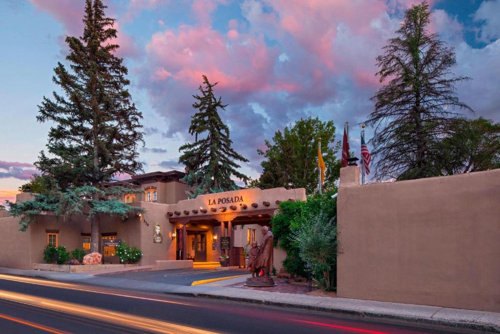 a building on the side of a street with trees at La Posada De Santa Fe, a Tribute Portfolio Resort & Spa in Santa Fe