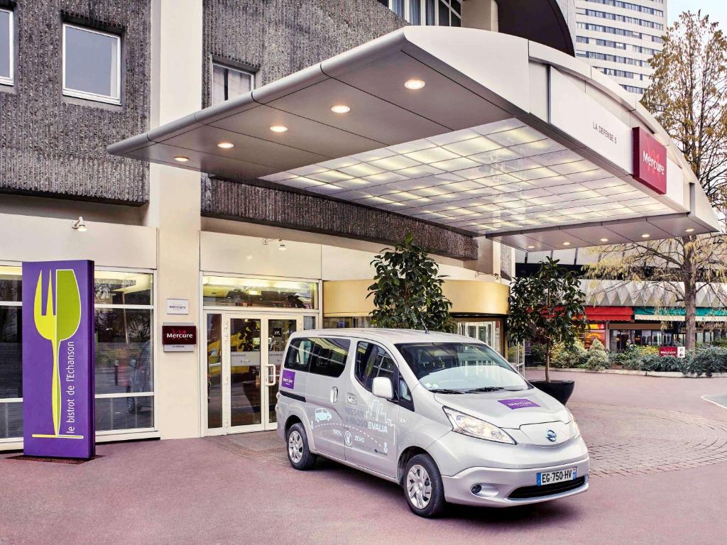 a small car parked in front of a store at Mercure Paris La Défense in Courbevoie
