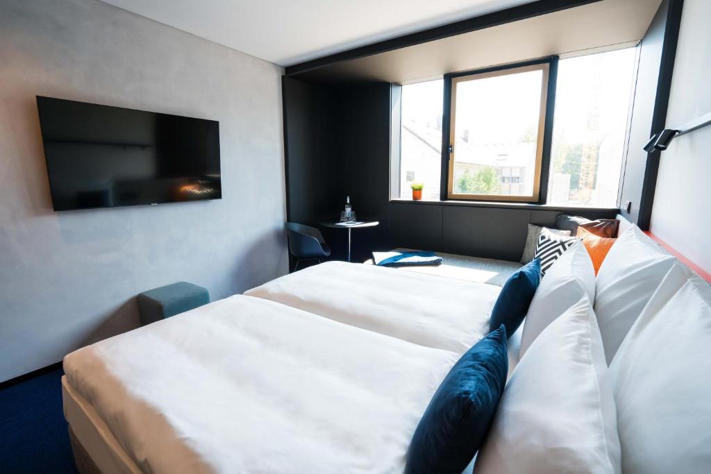 Postel nebo postele na pokoji v ubytování GREFIS Hotel