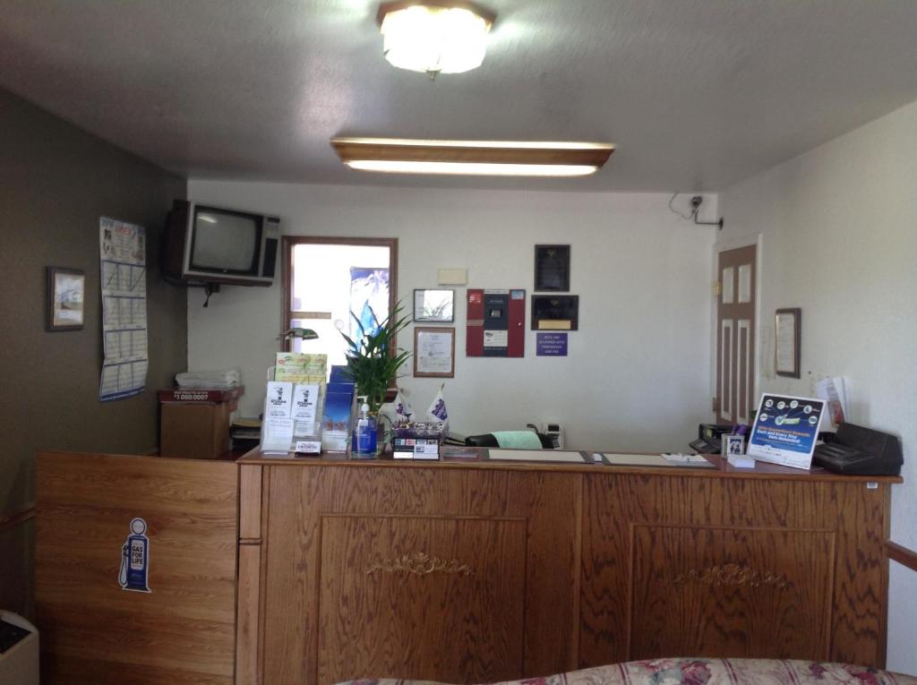 a reception desk in a room with a television at Knights Inn Muskogee in Muskogee