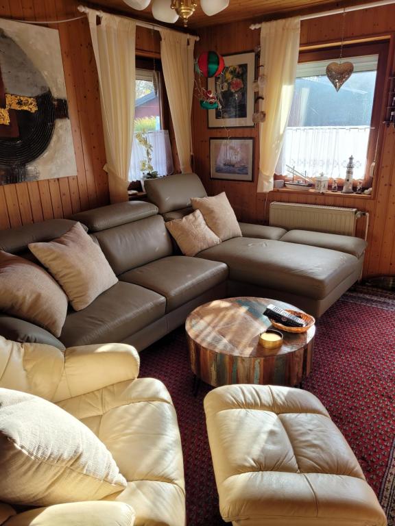 a living room with a couch and a table at Ferienhaus Lefering Stiftung in Otterndorf