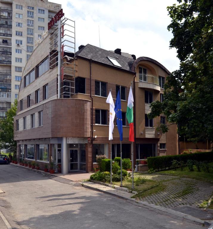 a building with three flags in front of it at Elate Plaza Hotel in Sofia