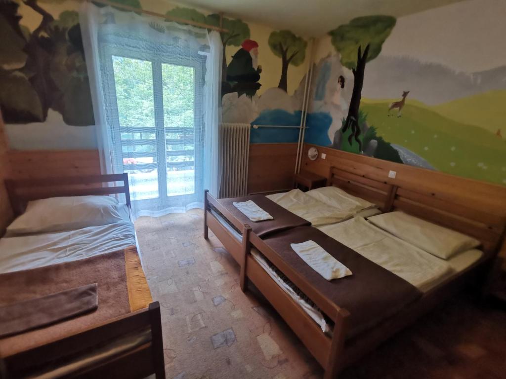 Postel nebo postele na pokoji v ubytování Hostel pod Voglom