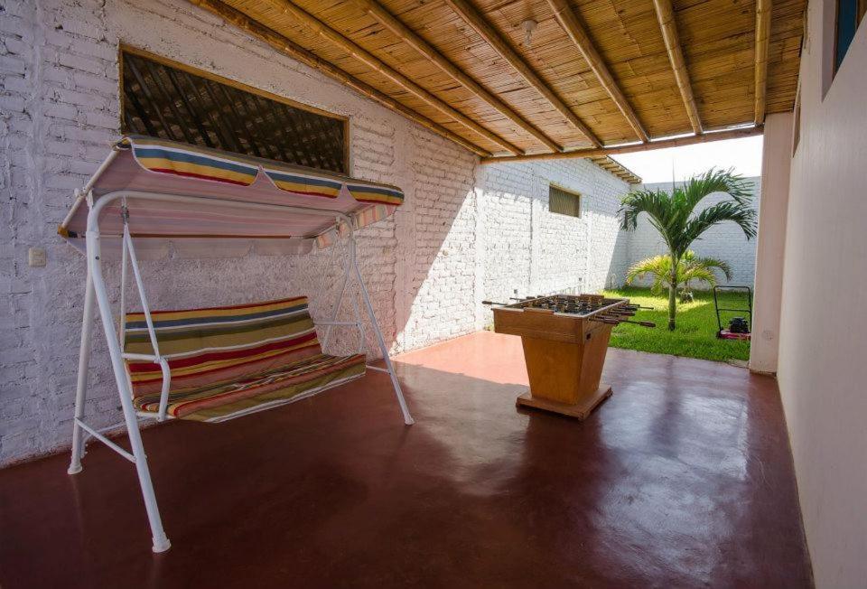 a room with a table and a stack of chairs at Mancora y Sol in Máncora
