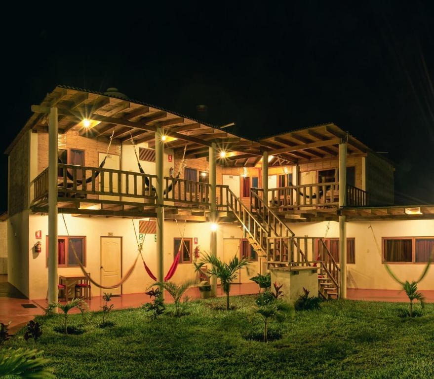 a building with a staircase in front of it at night at Mancora y Sol in Máncora