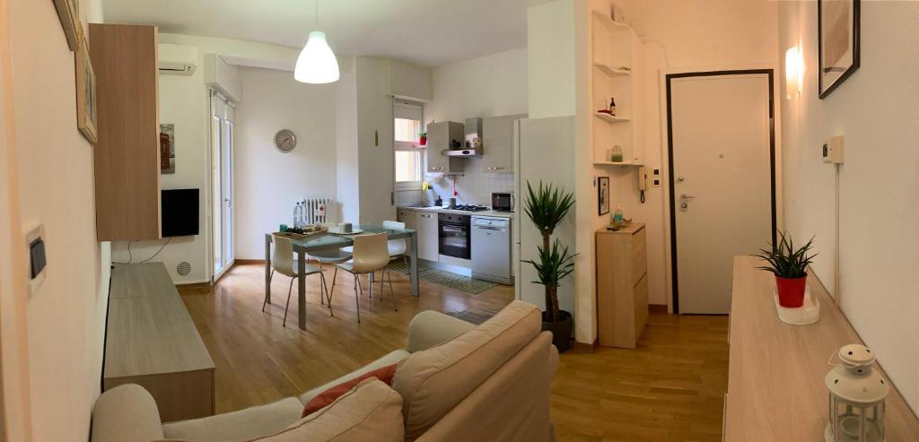 a living room and kitchen with a couch and a table at CASA BARTOLINI in Bologna