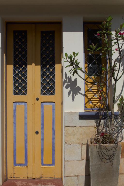 a yellow door and a window on a building at Casa Diamantina in Diamantina
