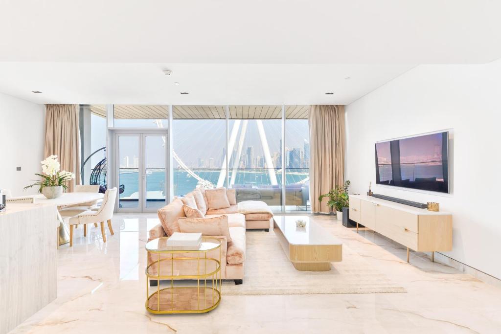 a living room with a couch and a tv at Contemporary and Spacious 2 BR in Bluewaters Island in Dubai