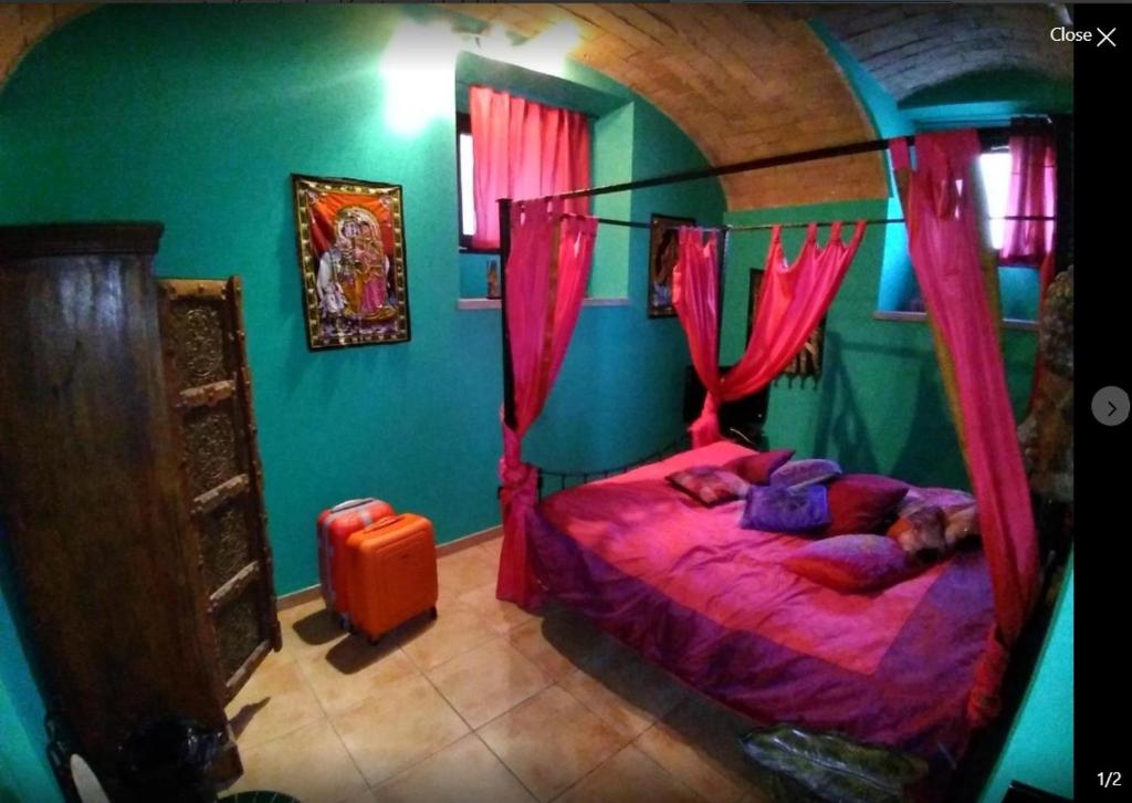 ローマにあるShiva B&Bのベッドルーム1室(ピンクのカーテン付きのベッド1台付)