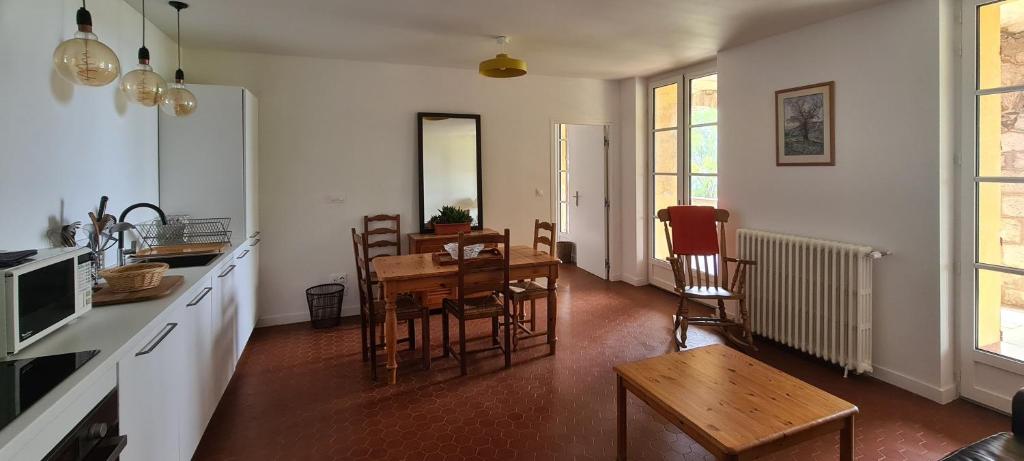a kitchen and dining room with a table and chairs at Gîte Marronnier in Tourrettes-sur-Loup
