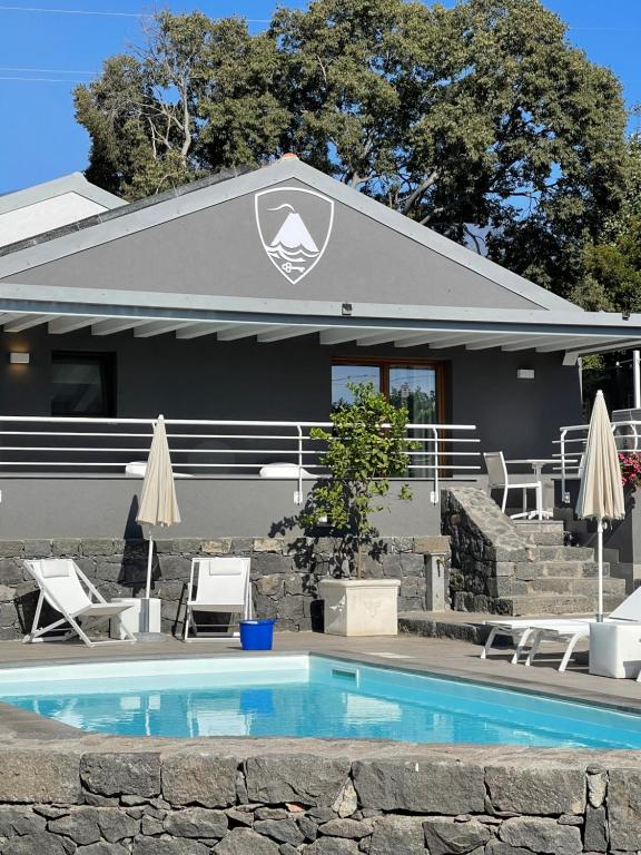 a swimming pool in front of a house at Vulcano SudEst in Santa Venerina