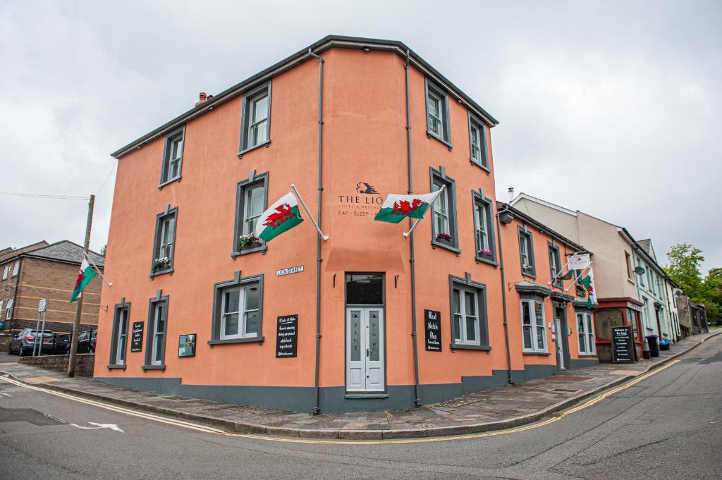 a building with flags in front of it on a street at The Lion Hotel in Blaenavon