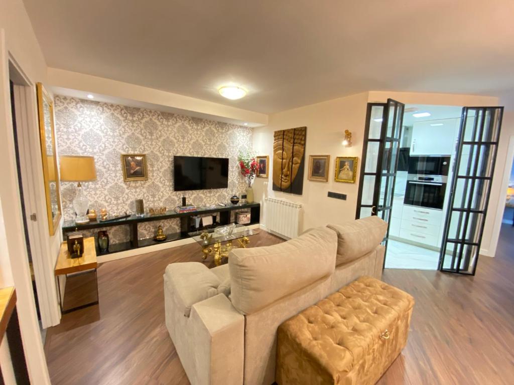 a living room with a couch and a tv at Charming Plaza de España in Madrid