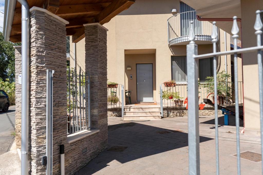 a brick house with a porch and a balcony at IL Sogno in Montesano sulla Marcellana