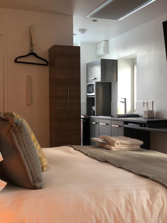 A bed or beds in a room at The Bell Guesthouse 