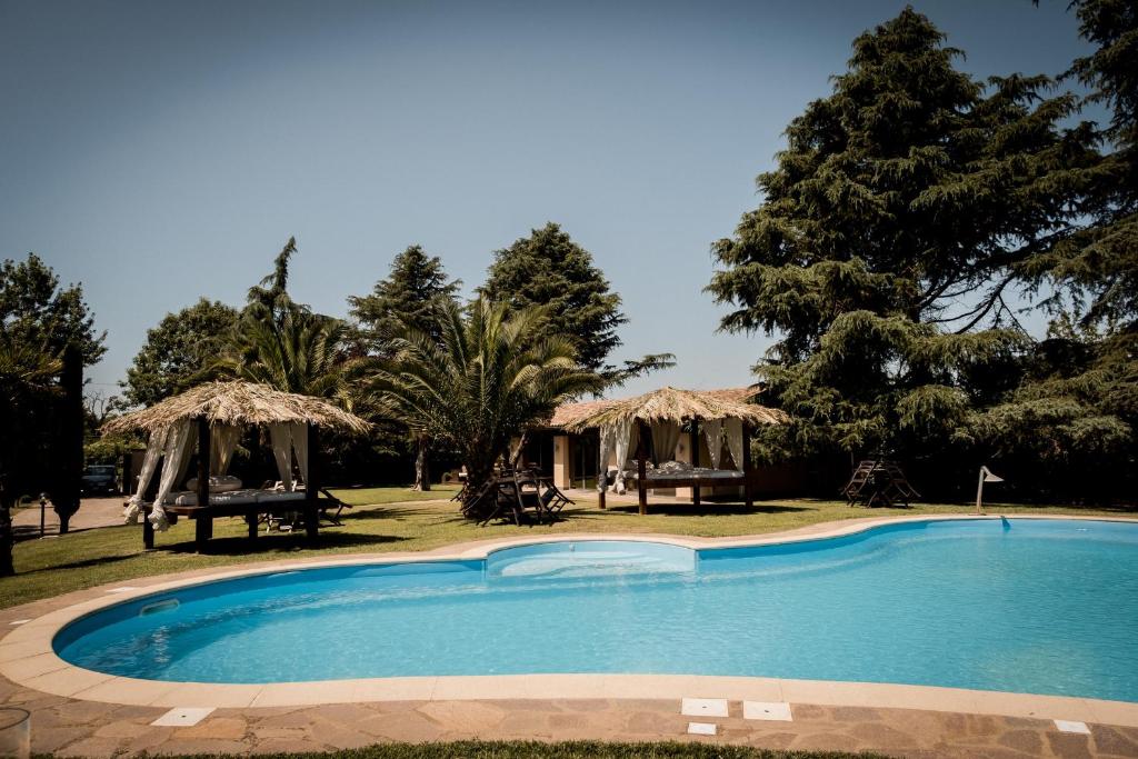 a swimming pool in the middle of a yard with trees at Villa Iulia in Vetralla