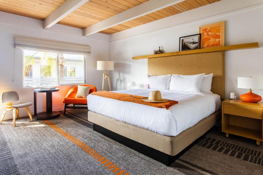 a bedroom with a large bed with a hat on it at Dr Wilkinsons Backyard Resort and Mineral Springs a Member of Design Hotels in Calistoga