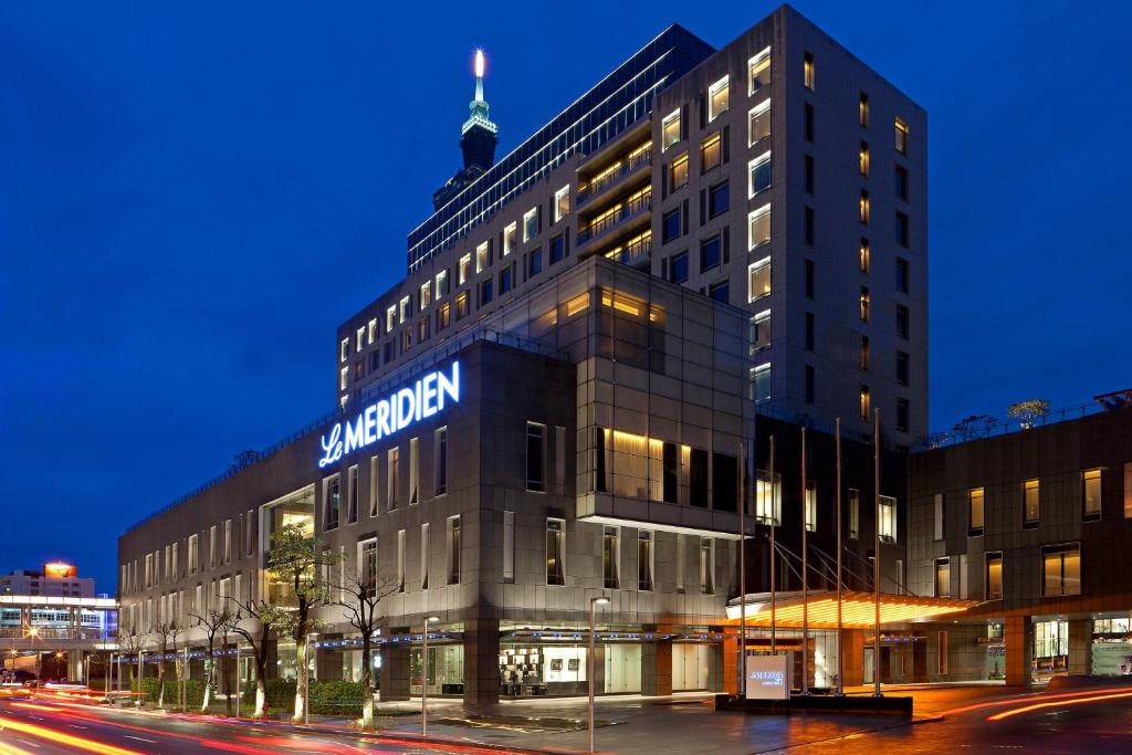 a large building with a clock on the side of it at Le Meridien Taipei in Taipei