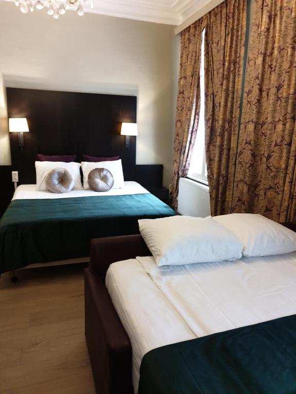 Postel nebo postele na pokoji v ubytování Hotel Gulden Vlies