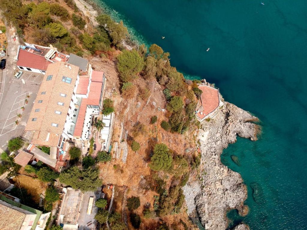 an aerial view of a resort on a cliff next to the water at Luna Convento Copanello B&B in Stalettì