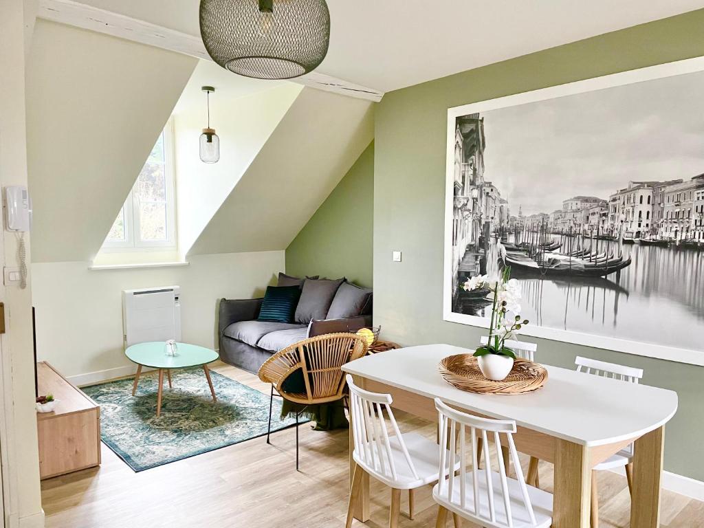 a living room with a table and a couch at Arina & Julien Dieppe in Dieppe