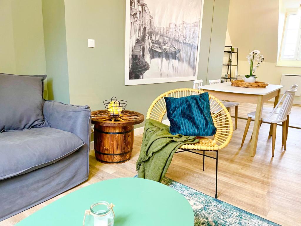 a living room with a couch and a table at Arina & Julien Dieppe in Dieppe
