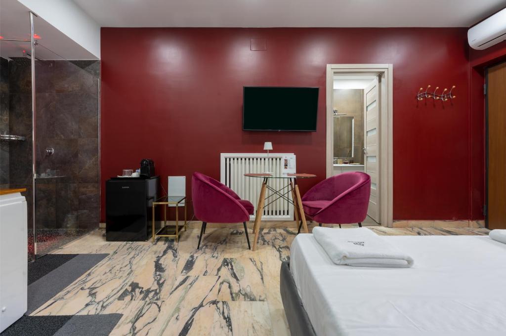 TV a/nebo společenská místnost v ubytování Hotel Ibisco Suites & Relax